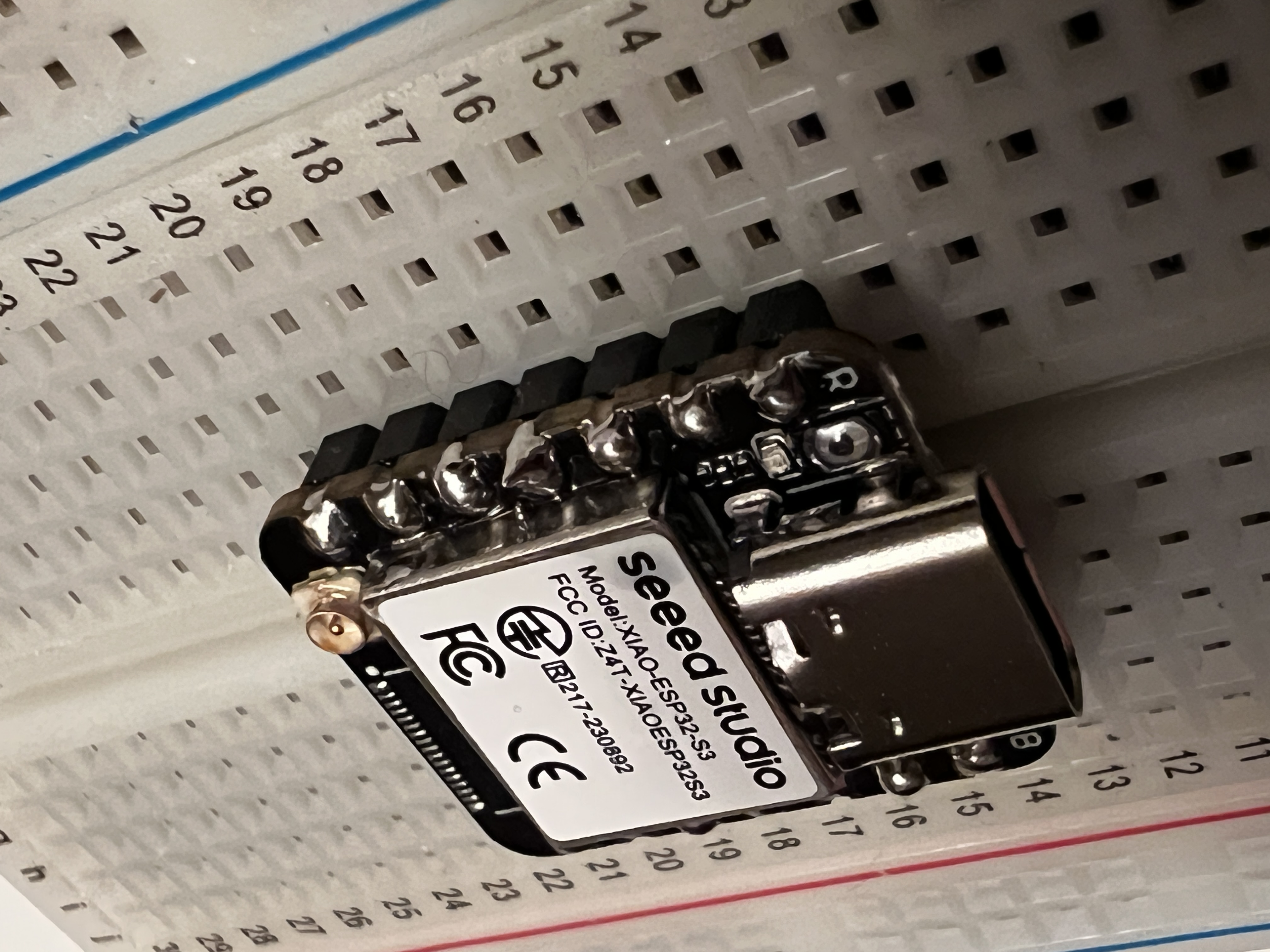 The little XIAO microcontroller on a breadboard, dwarfed by the wires around it.
